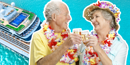 two baby boomers with leis on and clinking glasses of wine on vacation, with a cruise ship background
