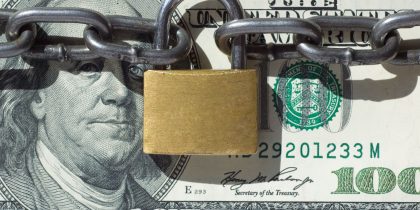 money, hundred dollar bill locked up with pad lock