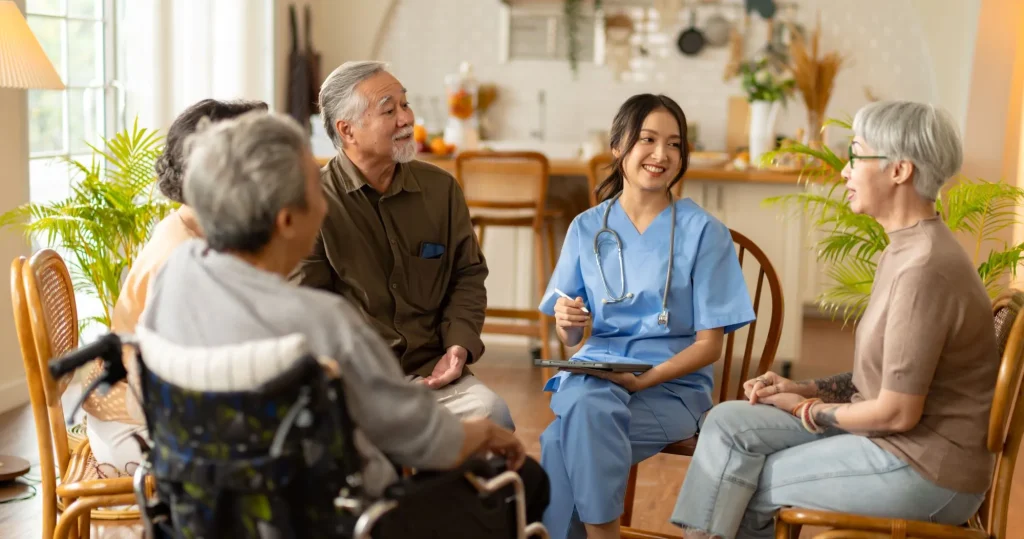 group of older asian adults talking to young nurse
