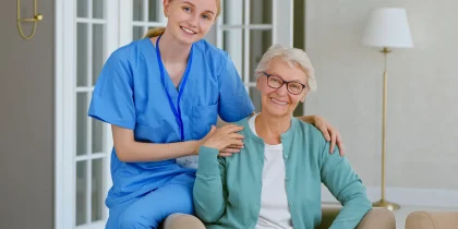 nurse and older woman smiling at camera