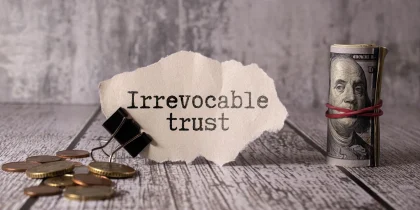 Irrevocable trust text on white sticker and pen