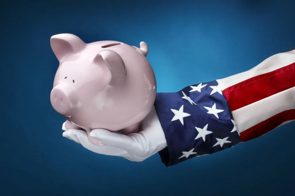 Close up shot of Uncle Sam holding pink piggy bank symbolizing government money, spending, budgeting, Medicare, Social Security