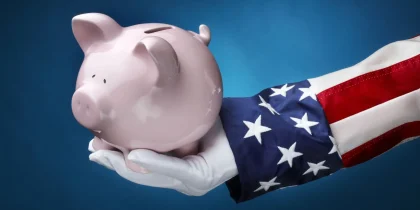 Close up shot of Uncle Sam holding pink piggy bank symbolizing government money, spending, budgeting, Medicare, Social Security